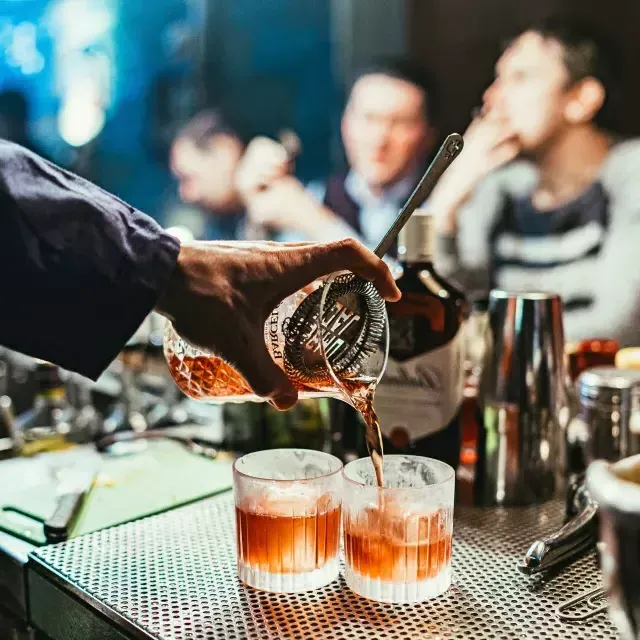 Bartender pouring cocktails